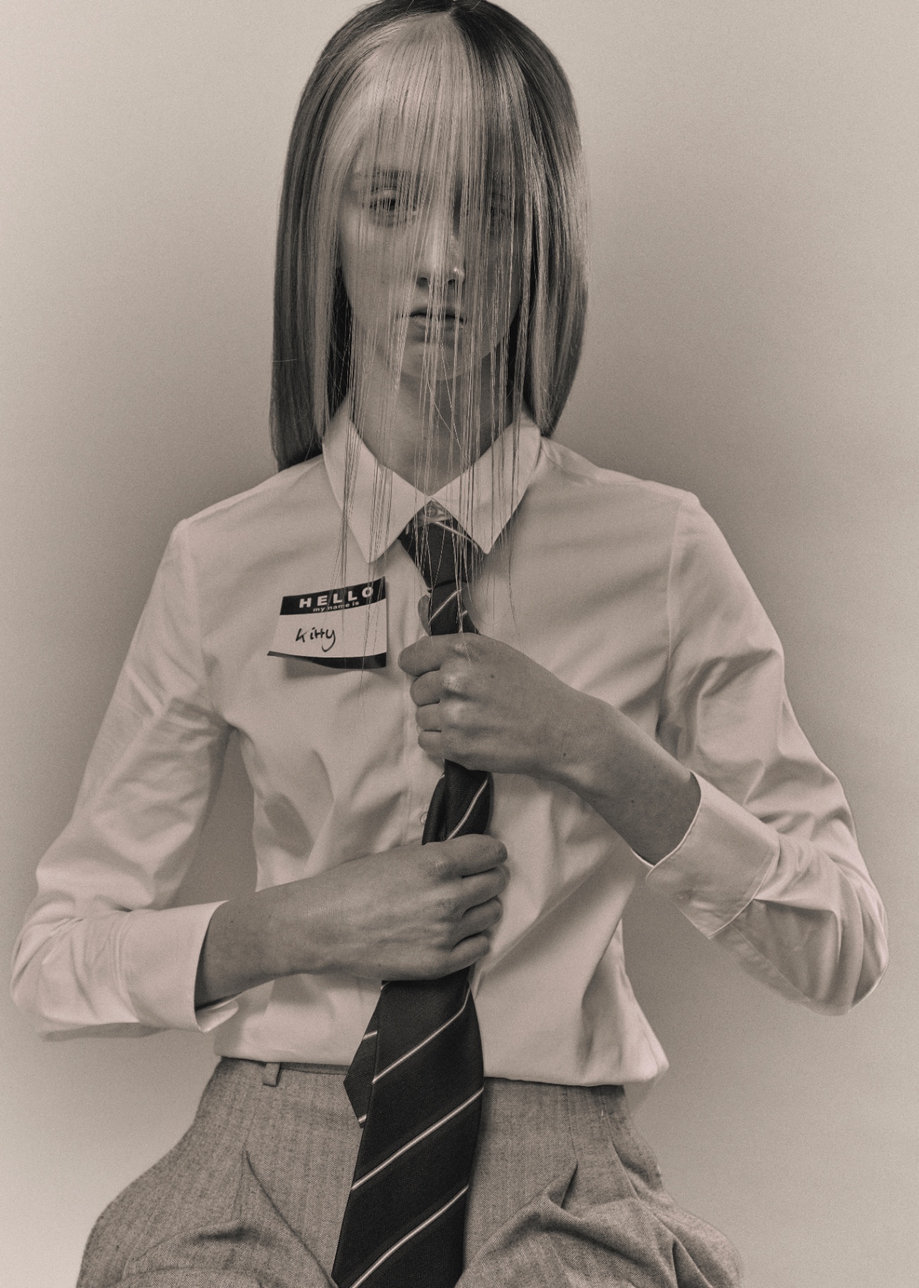 Monochrome portrait with tie and hair veil over face