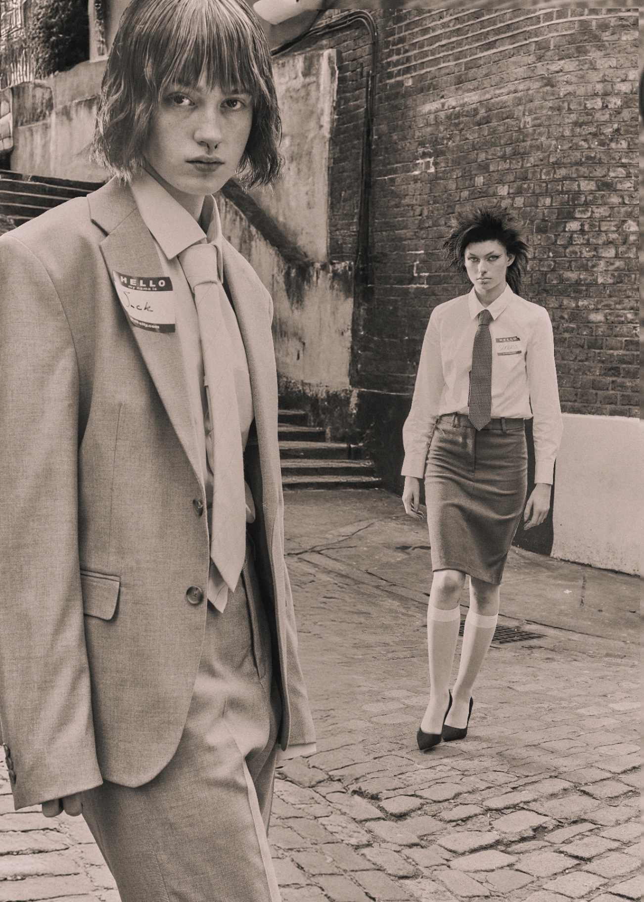 Black and white street fashion scene with two suited figures