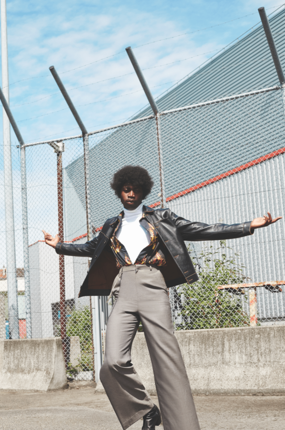 Fashion portrait posing in front of a fence
