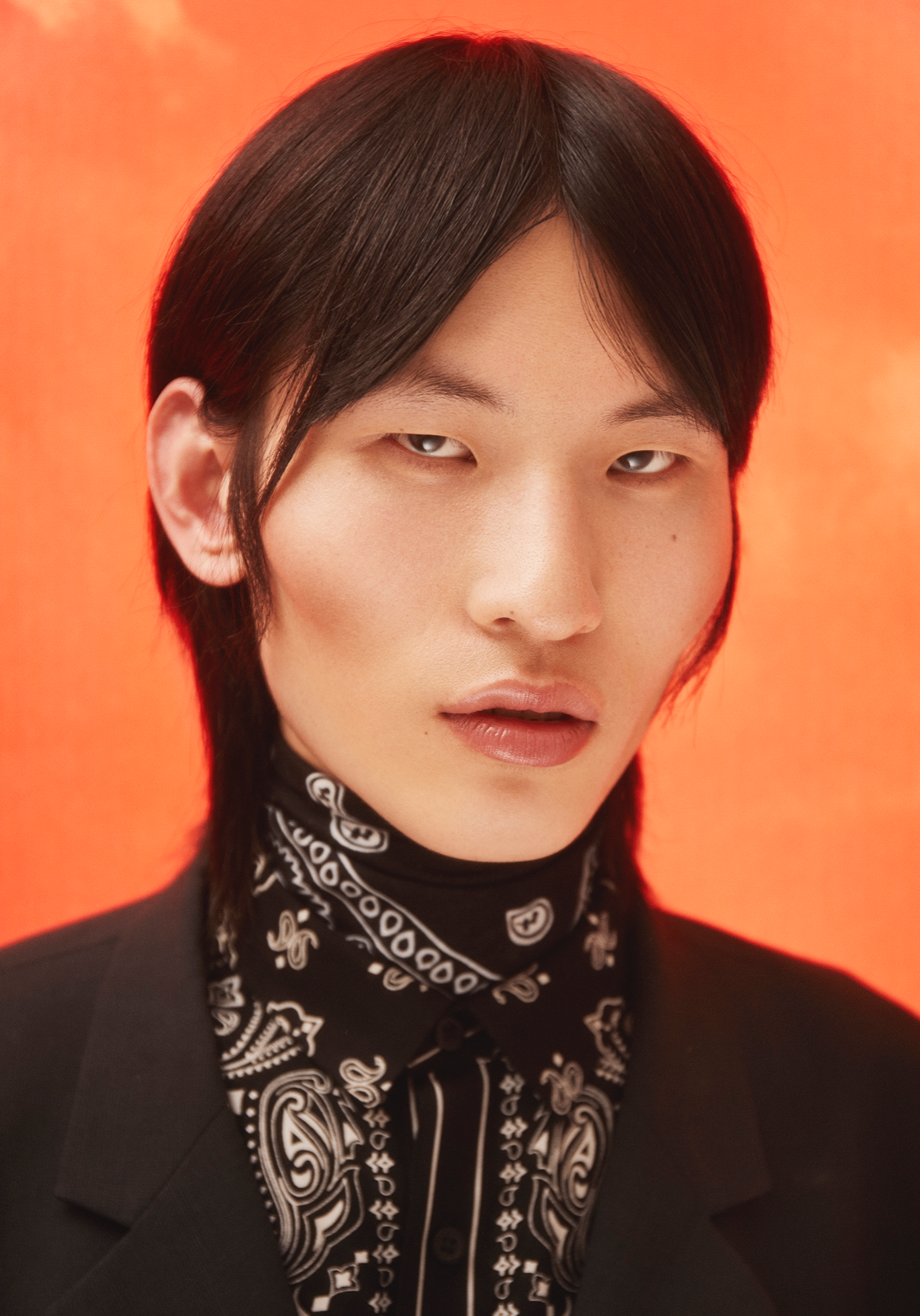 Close portrait with bandana and turtleneck on orange backdrop