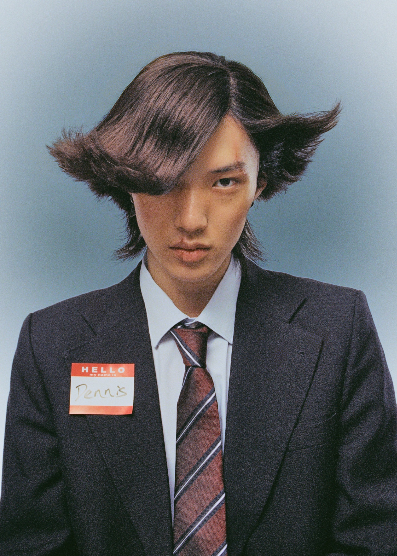 Centered portrait with dramatic sculpted hairstyle
