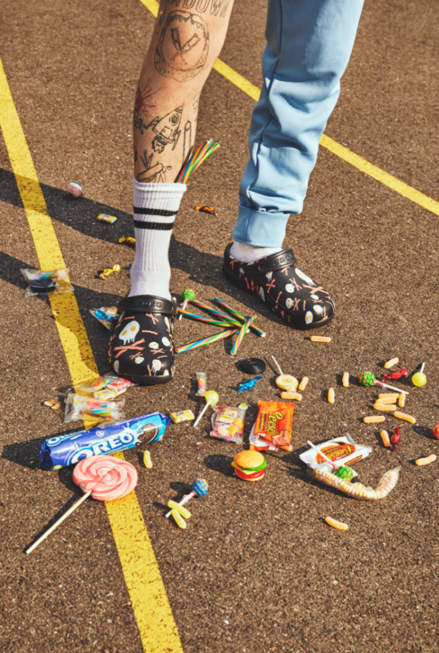 Fashion editorial detail with candies scattered on asphalt